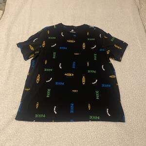 Nike Swoosh 50 All Over Logo Print T-Shirt in Black and Gold. Like new